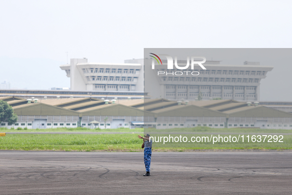 A soldier is on duty during the TNI Transport Aircraft Static Show event to commemorate the 79th Anniversary of the TNI at Husein Sastranega...