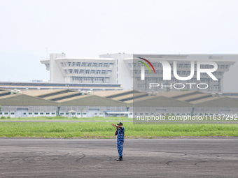 A soldier is on duty during the TNI Transport Aircraft Static Show event to commemorate the 79th Anniversary of the TNI at Husein Sastranega...