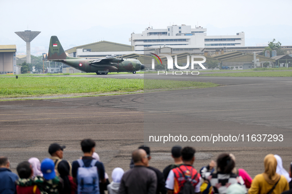 A number of residents watch aircraft landing during the TNI Transport Aircraft Static Show event to commemorate the 79th Anniversary of the...