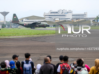 A number of residents watch aircraft landing during the TNI Transport Aircraft Static Show event to commemorate the 79th Anniversary of the...