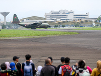 A number of residents watch aircraft landing during the TNI Transport Aircraft Static Show event to commemorate the 79th Anniversary of the...