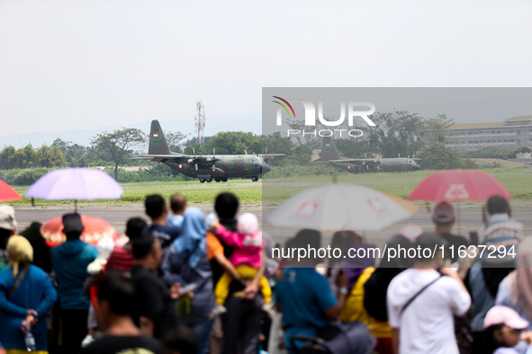 A number of residents watch aircraft landing during the TNI Transport Aircraft Static Show event to commemorate the 79th Anniversary of the...