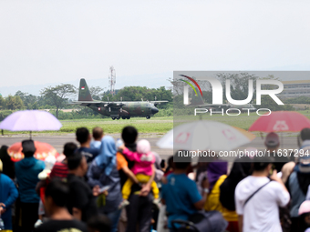 A number of residents watch aircraft landing during the TNI Transport Aircraft Static Show event to commemorate the 79th Anniversary of the...