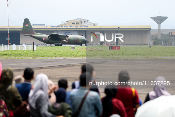 A number of residents watch aircraft landing during the TNI Transport Aircraft Static Show event to commemorate the 79th Anniversary of the...