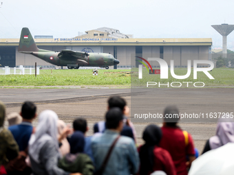 A number of residents watch aircraft landing during the TNI Transport Aircraft Static Show event to commemorate the 79th Anniversary of the...