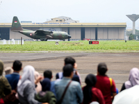 A number of residents watch aircraft landing during the TNI Transport Aircraft Static Show event to commemorate the 79th Anniversary of the...