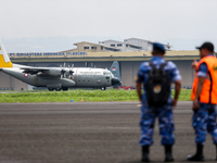 A number of soldiers watch aircraft landing during the TNI Transport Aircraft Static Show event to commemorate the 79th Anniversary of the T...