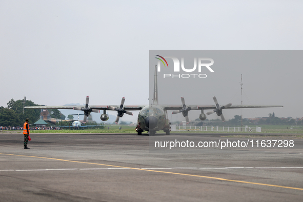 Aircraft land during the TNI Transport Aircraft Static Show event to commemorate the 79th Anniversary of the TNI at Husein Sastranegara Air...