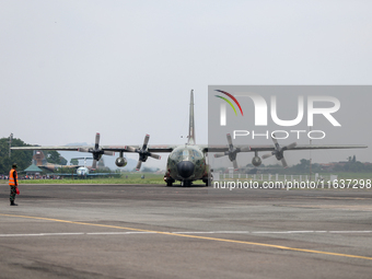 Aircraft land during the TNI Transport Aircraft Static Show event to commemorate the 79th Anniversary of the TNI at Husein Sastranegara Air...