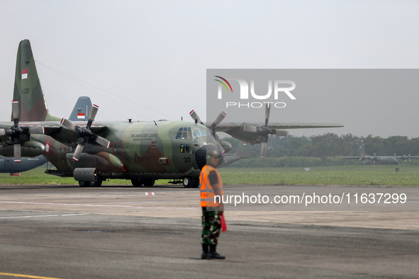 Aircraft land during the TNI Transport Aircraft Static Show event to commemorate the 79th Anniversary of the TNI at Husein Sastranegara Air...