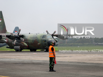 Aircraft land during the TNI Transport Aircraft Static Show event to commemorate the 79th Anniversary of the TNI at Husein Sastranegara Air...