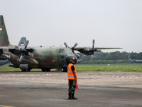 Aircraft land during the TNI Transport Aircraft Static Show event to commemorate the 79th Anniversary of the TNI at Husein Sastranegara Air...