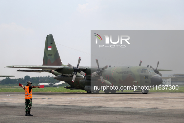 Aircraft land during the TNI Transport Aircraft Static Show event to commemorate the 79th Anniversary of the TNI at Husein Sastranegara Air...