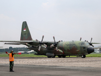 Aircraft land during the TNI Transport Aircraft Static Show event to commemorate the 79th Anniversary of the TNI at Husein Sastranegara Air...