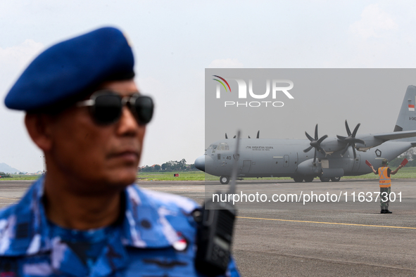 Aircraft land during the TNI Transport Aircraft Static Show event to commemorate the 79th Anniversary of the TNI at Husein Sastranegara Air...