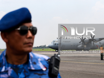 Aircraft land during the TNI Transport Aircraft Static Show event to commemorate the 79th Anniversary of the TNI at Husein Sastranegara Air...