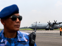 Aircraft land during the TNI Transport Aircraft Static Show event to commemorate the 79th Anniversary of the TNI at Husein Sastranegara Air...