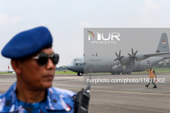 Aircraft land during the TNI Transport Aircraft Static Show event to commemorate the 79th Anniversary of the TNI at Husein Sastranegara Air...