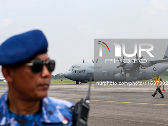 Aircraft land during the TNI Transport Aircraft Static Show event to commemorate the 79th Anniversary of the TNI at Husein Sastranegara Air...