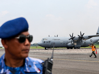 Aircraft land during the TNI Transport Aircraft Static Show event to commemorate the 79th Anniversary of the TNI at Husein Sastranegara Air...