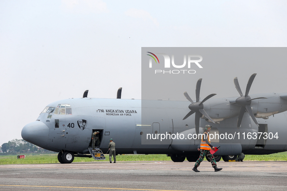 The crew exits the aircraft during the TNI Transport Aircraft Static Show event to commemorate the 79th Anniversary of the TNI at Husein Sas...