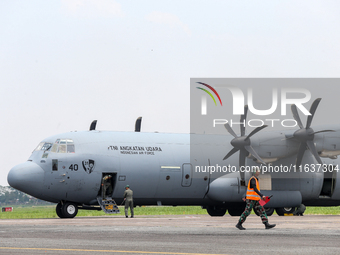 The crew exits the aircraft during the TNI Transport Aircraft Static Show event to commemorate the 79th Anniversary of the TNI at Husein Sas...