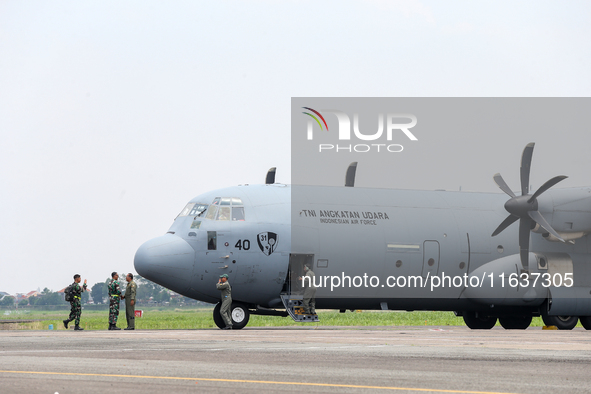 The crew exits the aircraft during the TNI Transport Aircraft Static Show event to commemorate the 79th Anniversary of the TNI at Husein Sas...