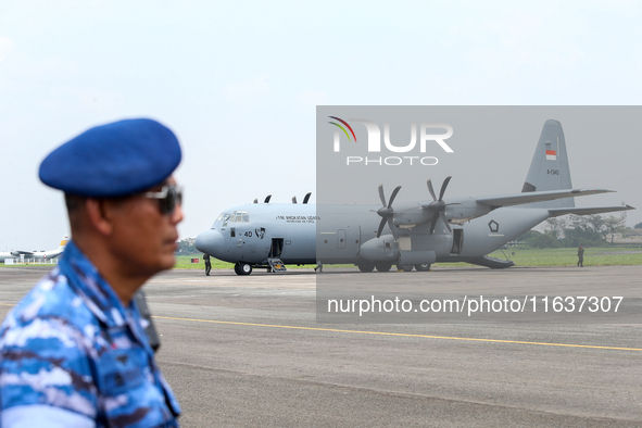 Aircraft land during the TNI Transport Aircraft Static Show event to commemorate the 79th Anniversary of the TNI at Husein Sastranegara Air...