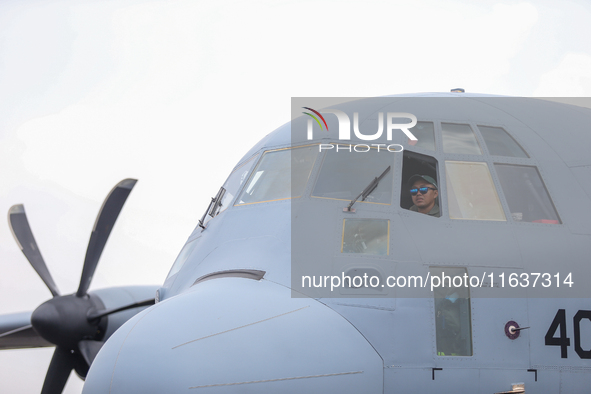 Pilots are inside a parked aircraft during the TNI Transport Aircraft Static Show event to commemorate the 79th Anniversary of the TNI at Hu...