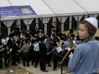 Children Orthodox Jewish pilgrims pray near the tomb of Rabbi Nachman while celebrating Rosh Hashanah, the Jewish New Year, amid the ongoing...