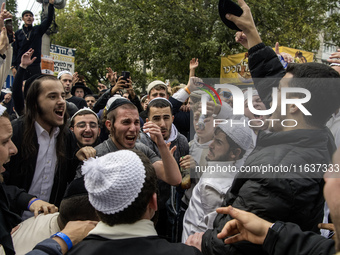 Orthodox Jewish pilgrims dance outside the tomb of Rabbi Nachman while celebrating Rosh Hashanah, the Jewish New Year, as Russia continues t...