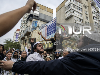 Orthodox Jewish pilgrims dance outside the tomb of Rabbi Nachman while celebrating Rosh Hashanah, the Jewish New Year, as Russia continues t...