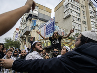 Orthodox Jewish pilgrims dance outside the tomb of Rabbi Nachman while celebrating Rosh Hashanah, the Jewish New Year, as Russia continues t...