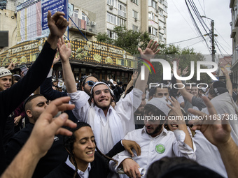 Orthodox Jewish pilgrims dance outside the tomb of Rabbi Nachman while celebrating Rosh Hashanah, the Jewish New Year, as Russia continues t...