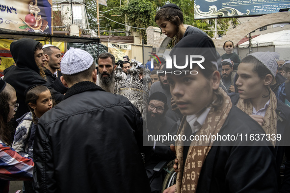 Ultra-Orthodox Jewish pilgrims carry the Torah near the tomb of Rabbi Nachman while celebrating Rosh Hashanah, the Jewish New Year, amid the...