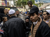 Ultra-Orthodox Jewish pilgrims carry the Torah near the tomb of Rabbi Nachman while celebrating Rosh Hashanah, the Jewish New Year, amid the...