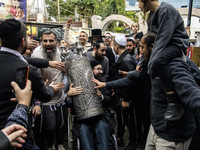 Ultra-Orthodox Jewish pilgrims carry the Torah near the tomb of Rabbi Nachman while celebrating Rosh Hashanah, the Jewish New Year, amid the...