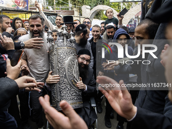 Ultra-Orthodox Jewish pilgrims carry the Torah near the tomb of Rabbi Nachman while celebrating Rosh Hashanah, the Jewish New Year, amid the...