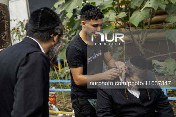 Ultra-Orthodox Jewish Hasidic pilgrims have haircuts on the eve of the Rosh Hashanah holiday, the Jewish New Year, near the tomb of Rabbi Na...