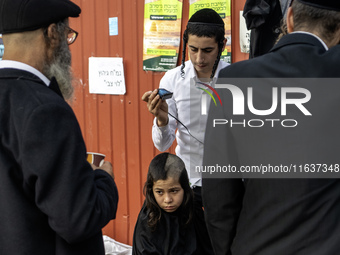 Ultra-Orthodox Jewish Hasidic pilgrims have haircuts on the eve of the Rosh Hashanah holiday, the Jewish New Year, near the tomb of Rabbi Na...