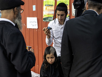 Ultra-Orthodox Jewish Hasidic pilgrims have haircuts on the eve of the Rosh Hashanah holiday, the Jewish New Year, near the tomb of Rabbi Na...