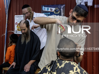 Ultra-Orthodox Jewish Hasidic pilgrims have haircuts on the eve of the Rosh Hashanah holiday, the Jewish New Year, near the tomb of Rabbi Na...