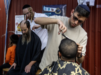 Ultra-Orthodox Jewish Hasidic pilgrims have haircuts on the eve of the Rosh Hashanah holiday, the Jewish New Year, near the tomb of Rabbi Na...