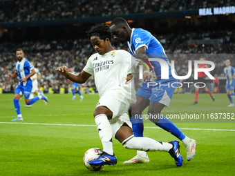 Endrick centre-forward of Real Madrid and Brazil and Moussa Diarra centre-back of Alaves and Mali compete for the ball during the La Liga ma...