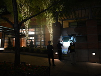 New York City Police Department crime scene investigators swab for evidence outside the One Carnegie Hill luxury rental apartment complex lo...