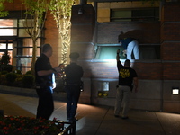 New York City Police Department crime scene investigators swab for evidence outside the One Carnegie Hill luxury rental apartment complex lo...