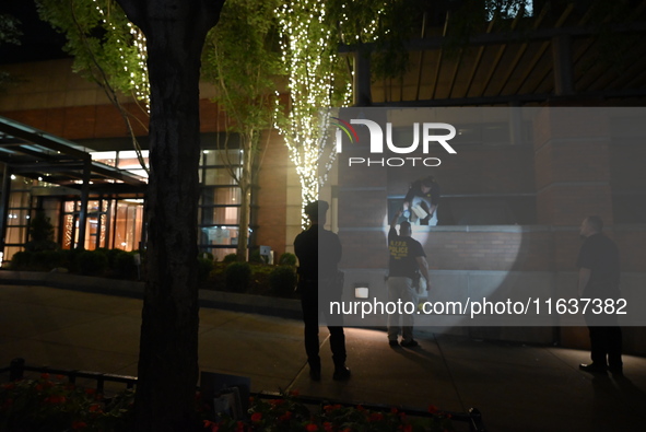 New York City Police Department crime scene investigators swab for evidence outside the One Carnegie Hill luxury rental apartment complex lo...