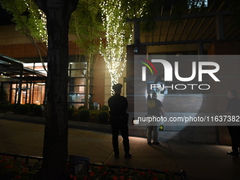 New York City Police Department crime scene investigators swab for evidence outside the One Carnegie Hill luxury rental apartment complex lo...