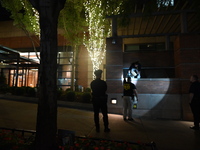 New York City Police Department crime scene investigators swab for evidence outside the One Carnegie Hill luxury rental apartment complex lo...