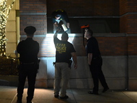 New York City Police Department crime scene investigators swab for evidence outside the One Carnegie Hill luxury rental apartment complex lo...